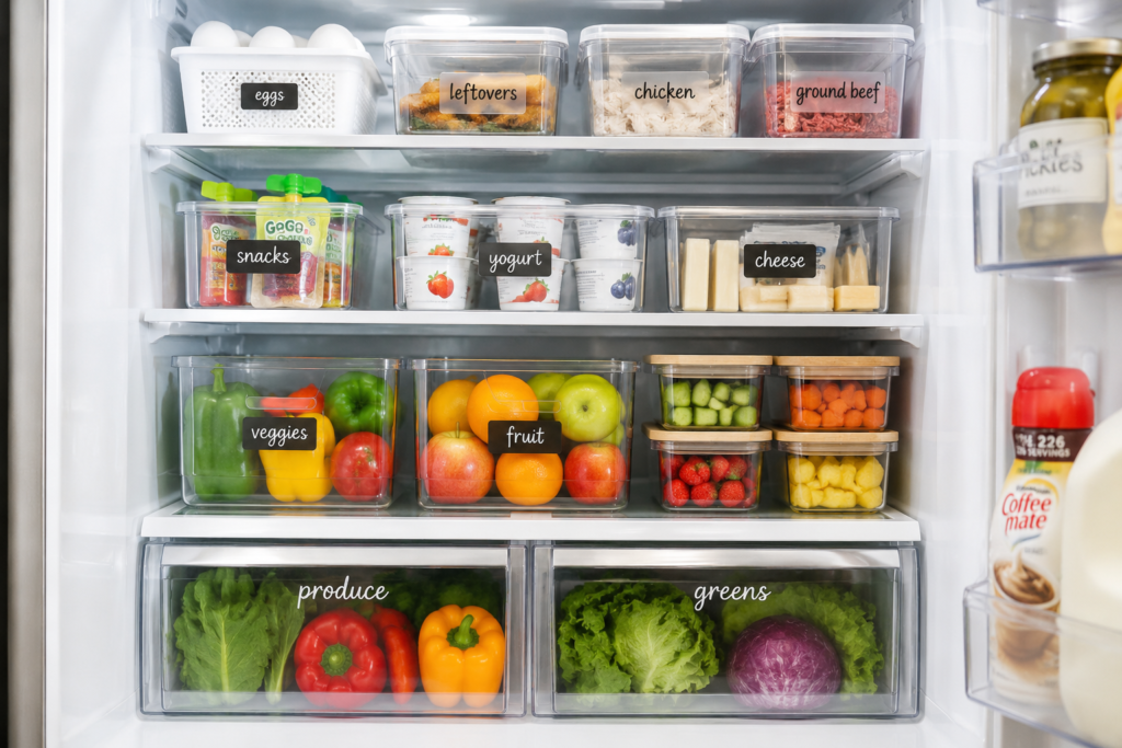 Organized refrigerator with clear containers and designated food zones